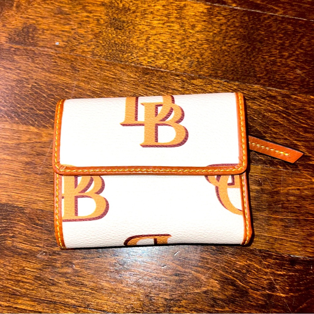 Dooney and Bourke trifold large monogram wallet. White